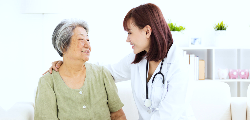 Smiling home caregiver with elderly woman