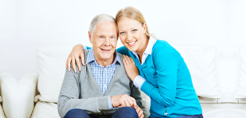 woman embracing elderly man